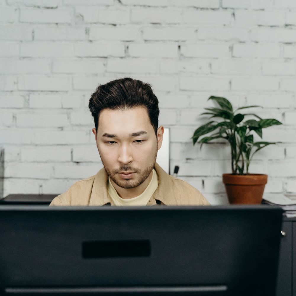A person working calmly at a computer in a quiet office